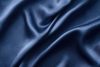 Silver Silk Background With A Folds. Abstract Texture Of Rippled Silk Surface