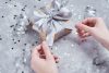 Woman Hand Tied Bow On Gift Box